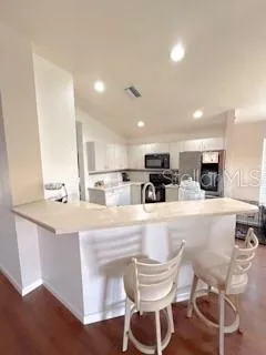 a large kitchen with a table and chairs