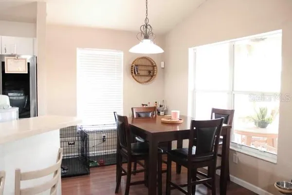 a dining room with furniture window and wooden floor