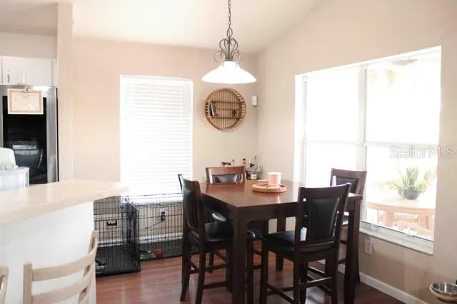 a dining room with furniture window and wooden floor