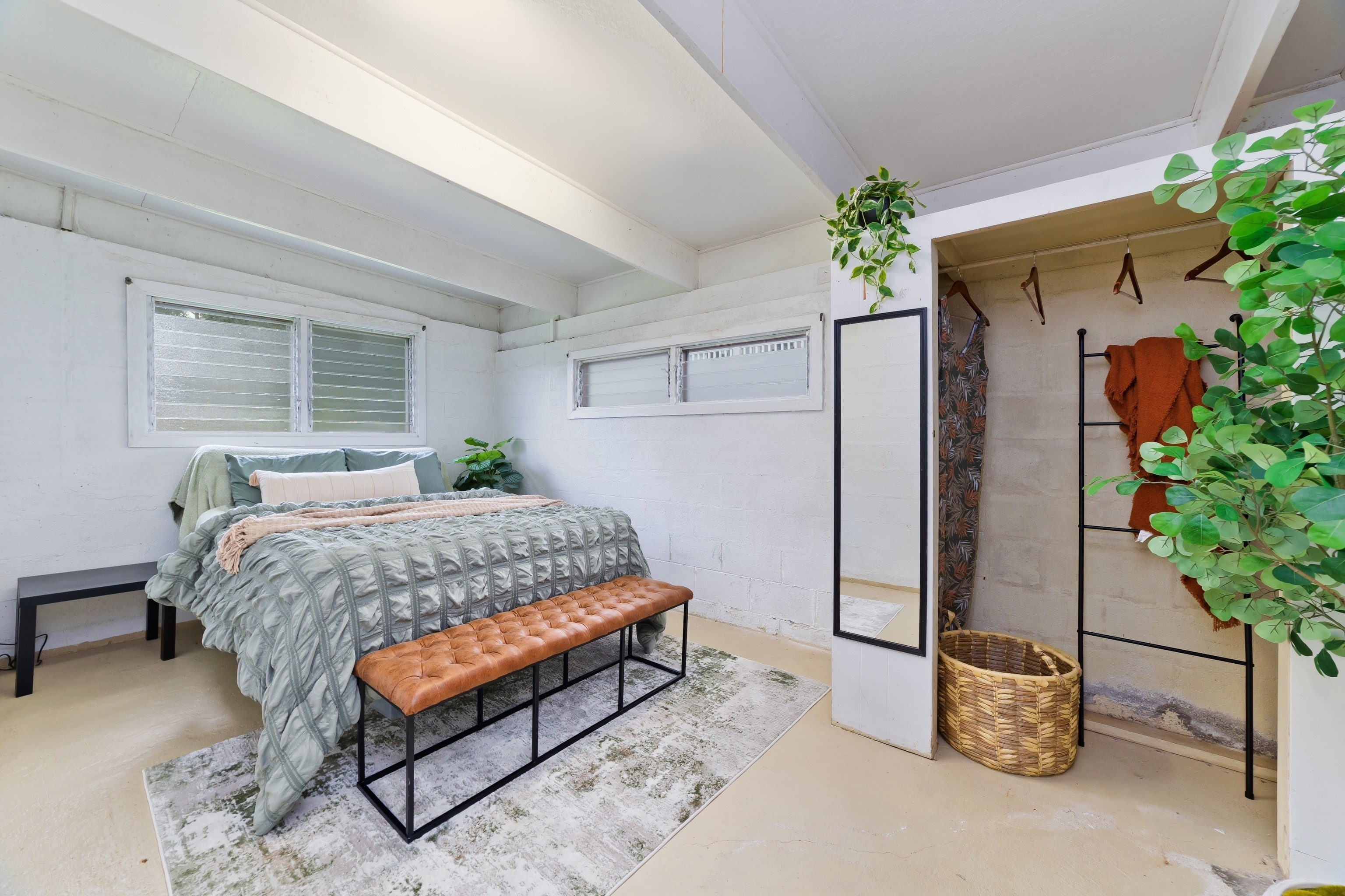 25 Wawai Loop Hilo, HI 96720 - Photo 15 of 22 a bedroom with a bed and a potted plant