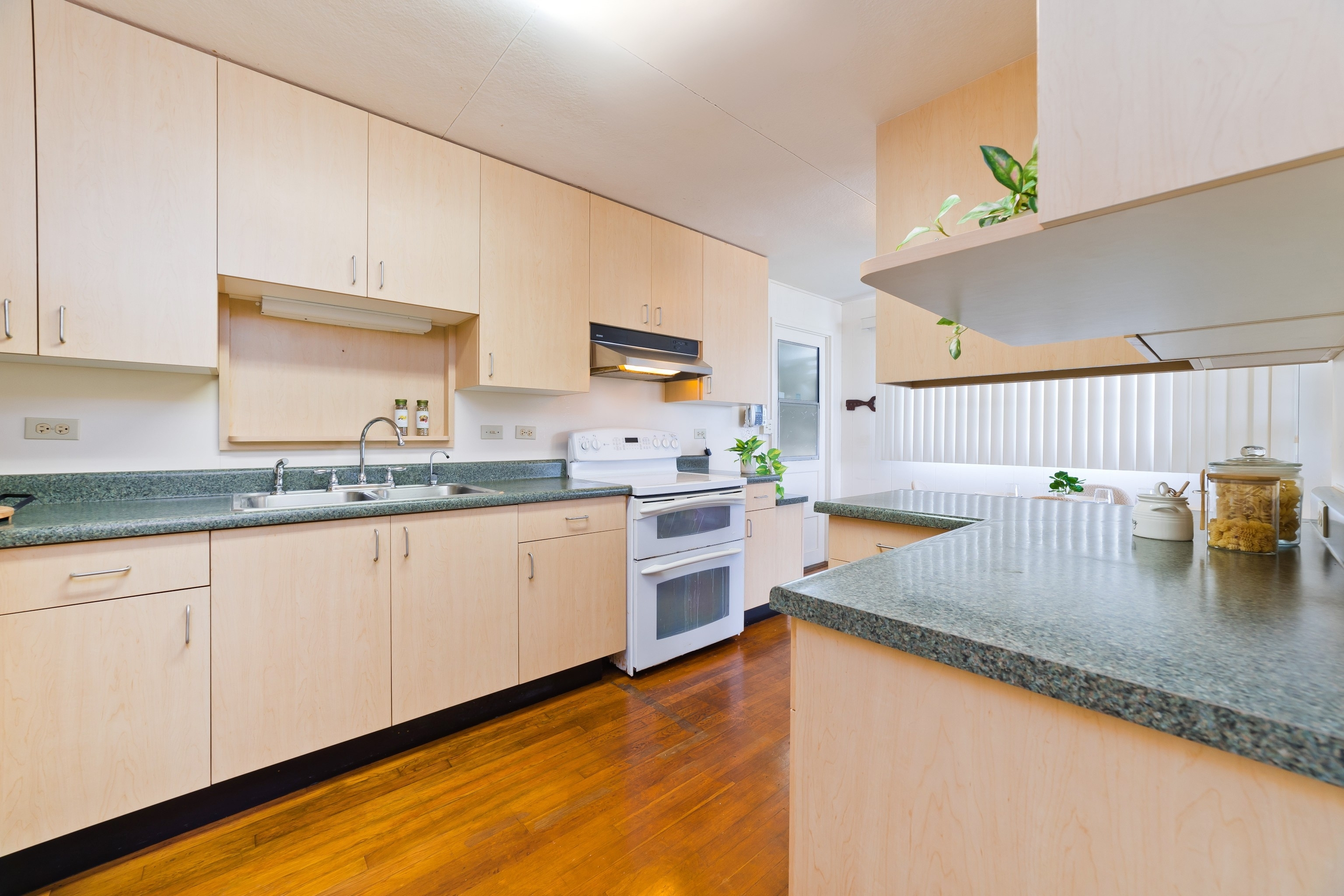 25 Wawai Loop Hilo, HI 96720 - Photo 6 of 22 a kitchen with sink a stove and cabinets