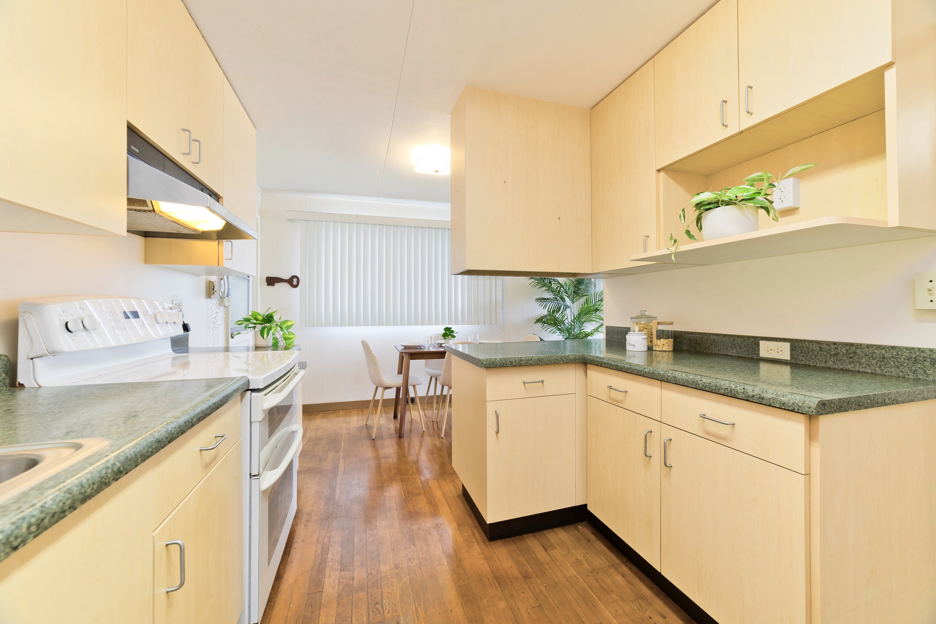 25 Wawai Loop Hilo, HI 96720 - Photo 7 of 22 a kitchen with granite countertop sink cabinets and wooden floor