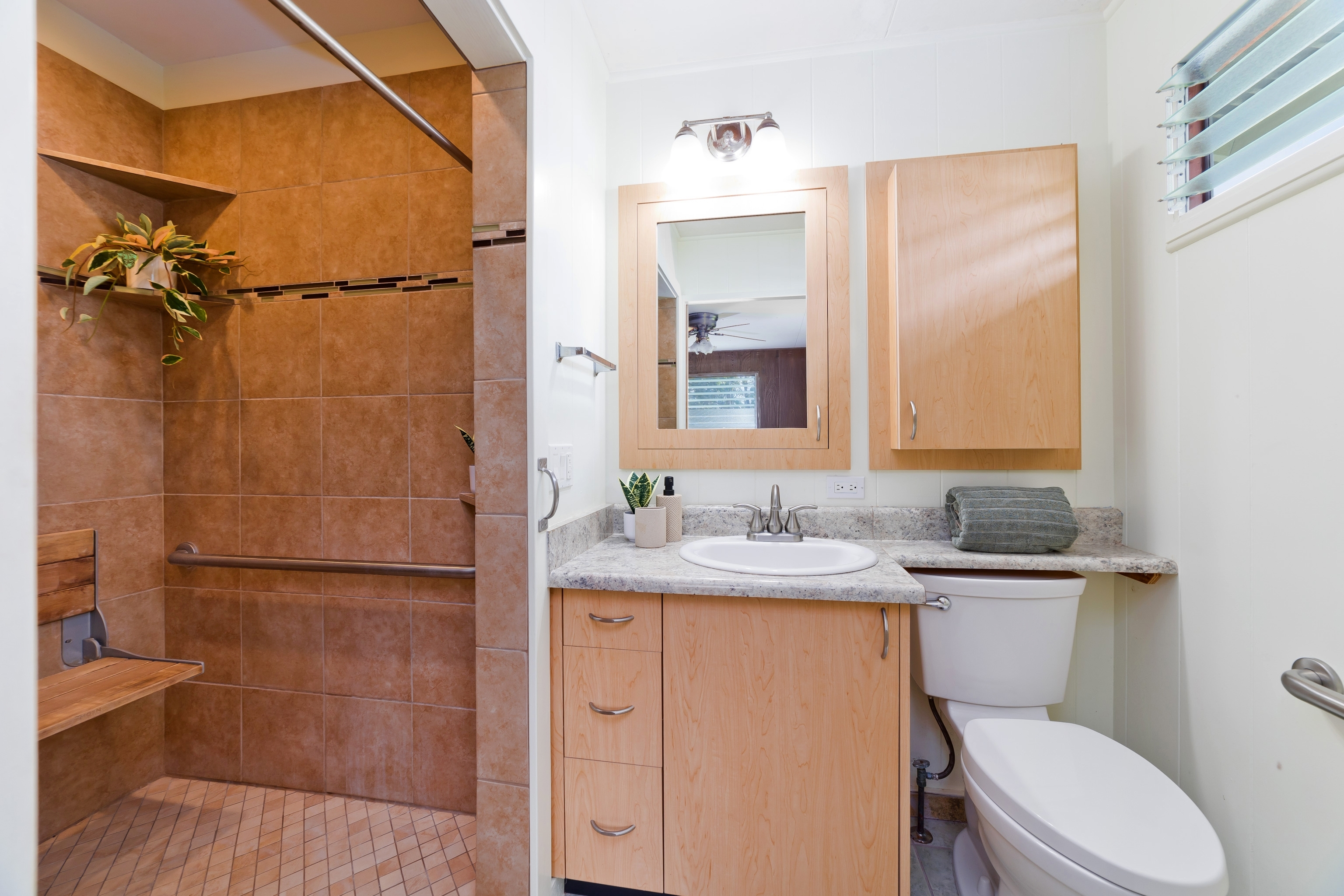 25 Wawai Loop Hilo, HI 96720 - Photo 9 of 22 a bathroom with a granite countertop sink toilet and shower