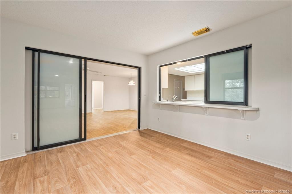 542 Woods Edge Trail Stuart, FL 34997 - Photo 12 of 31 a view of empty room with wooden floor and fan