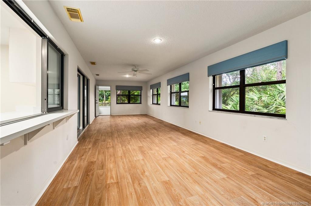 542 Woods Edge Trail Stuart, FL 34997 - Photo 14 of 31 wooden floor in an empty room with a window
