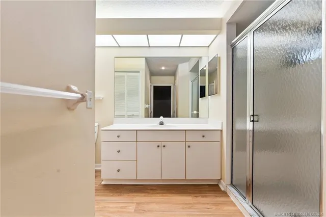 a spacious bathroom with a double vanity sink and a mirror