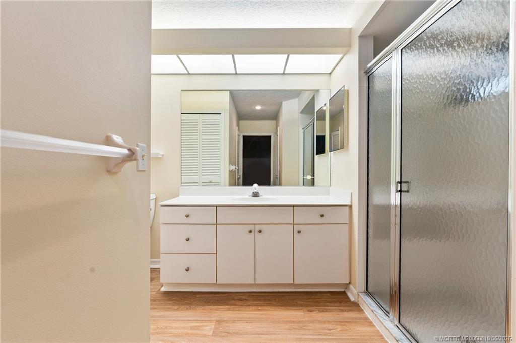 542 Woods Edge Trail Stuart, FL 34997 - Photo 20 of 31 a spacious bathroom with a double vanity sink and a mirror