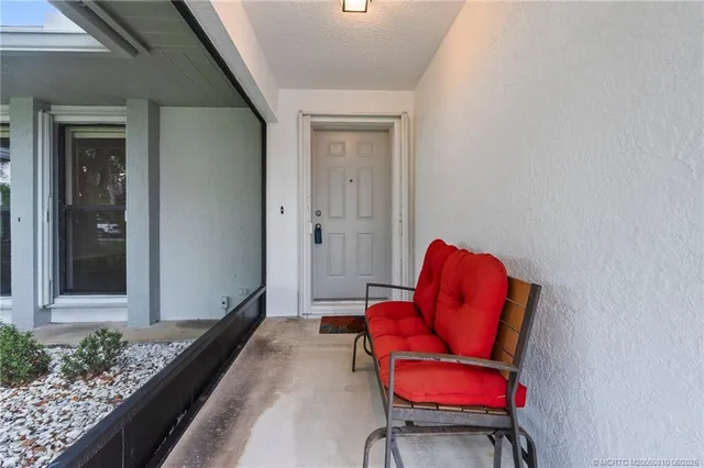 a living room with furniture and a chair