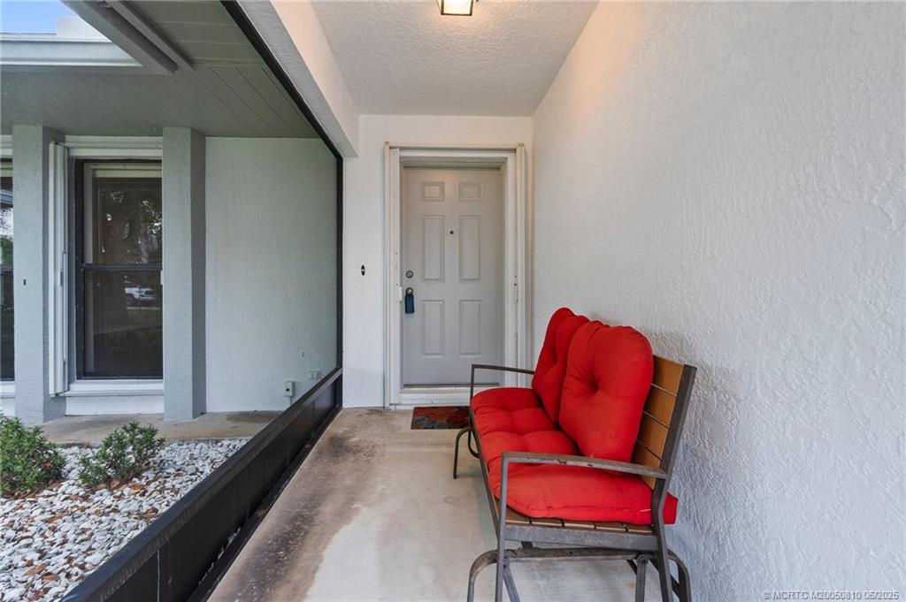 542 Woods Edge Trail Stuart, FL 34997 - Photo 2 of 31 a living room with furniture and a chair