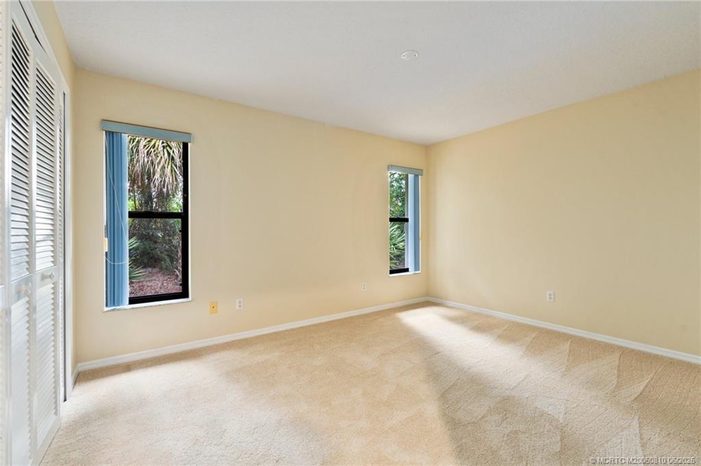 542 Woods Edge Trail Stuart, FL 34997 - Photo 22 of 31 an empty room with windows and closet