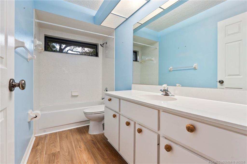 542 Woods Edge Trail Stuart, FL 34997 - Photo 24 of 31 a spacious bathroom with a double vanity sink a toilet and a mirror