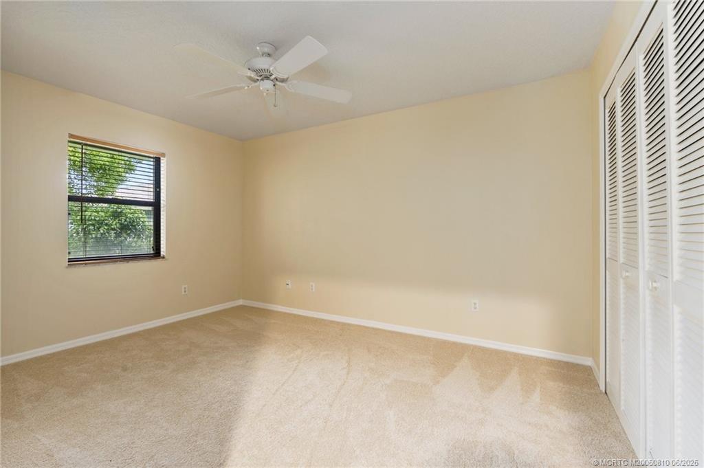 542 Woods Edge Trail Stuart, FL 34997 - Photo 25 of 31 an empty room with a window and a ceiling fan
