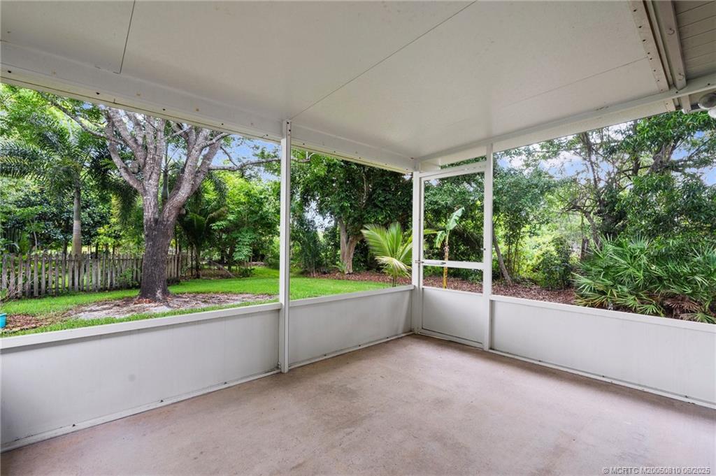 542 Woods Edge Trail Stuart, FL 34997 - Photo 26 of 31 a view of a garden with an outdoor seating space