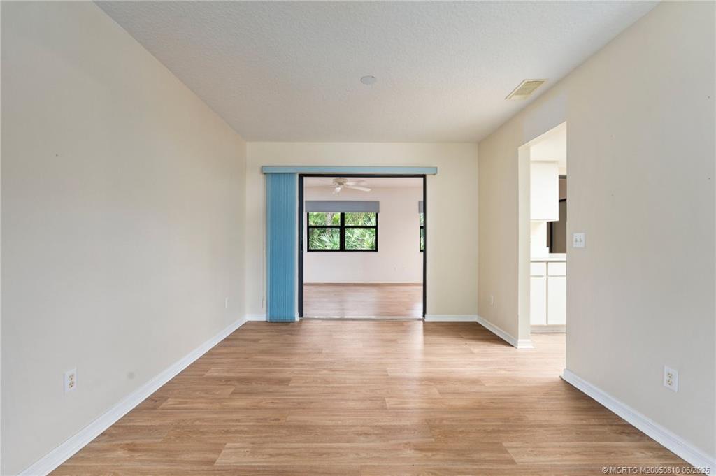 542 Woods Edge Trail Stuart, FL 34997 - Photo 7 of 31 wooden floor in an empty room with a window