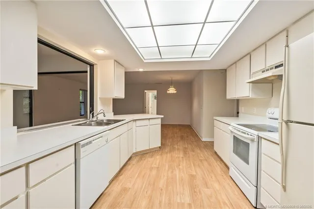 a large kitchen with a sink and cabinets