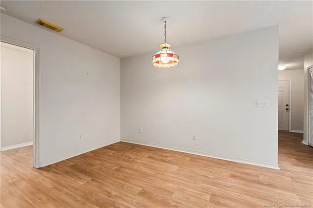 a big room with wooden floor and windows