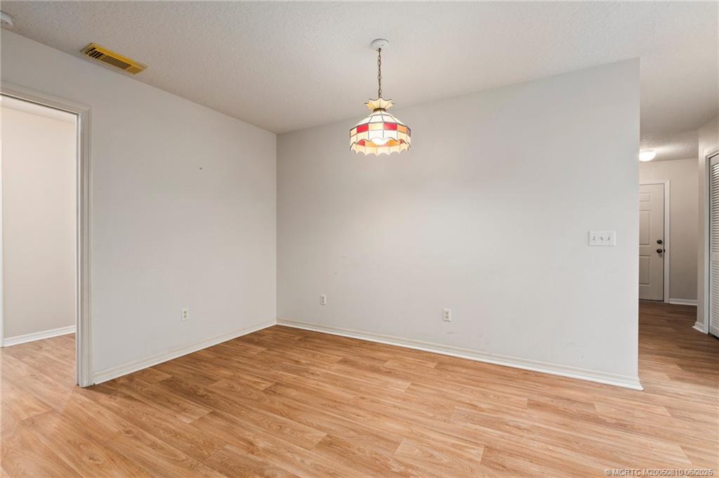 542 Woods Edge Trail Stuart, FL 34997 - Photo 10 of 31 a big room with wooden floor and windows