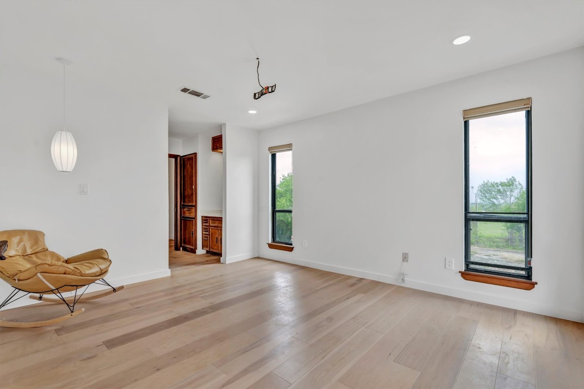1201 County Road 138 Hutto, TX 78634 - Photo 12 of 26 a view of an empty room with window and hardwood floor