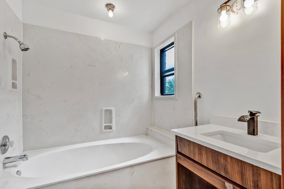 1201 County Road 138 Hutto, TX 78634 - Photo 13 of 26 a bathroom with a sink and a bathtub