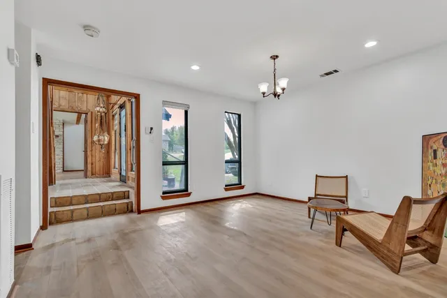 a view of a livingroom with furniture wooden floor and a ceiling fan