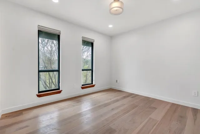 an empty room with windows and closet