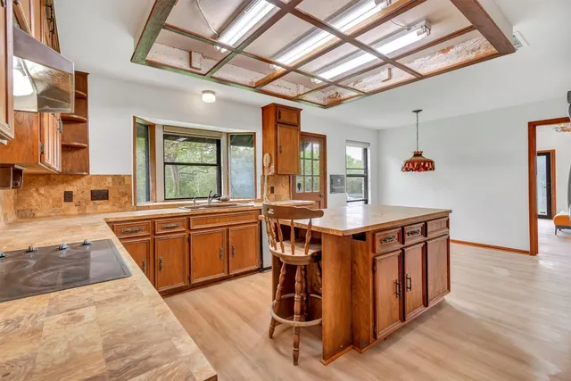 a kitchen with stainless steel appliances granite countertop a stove a sink and a refrigerator