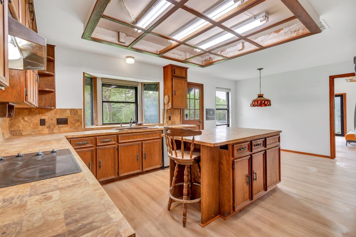 1201 County Road 138 Hutto, TX 78634 - Photo 19 of 26 a kitchen with stainless steel appliances granite countertop a stove a sink and a refrigerator
