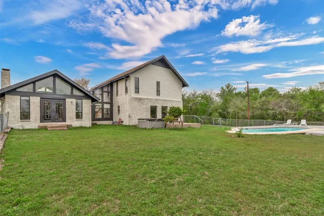 a view of a house with a yard patio and a garden