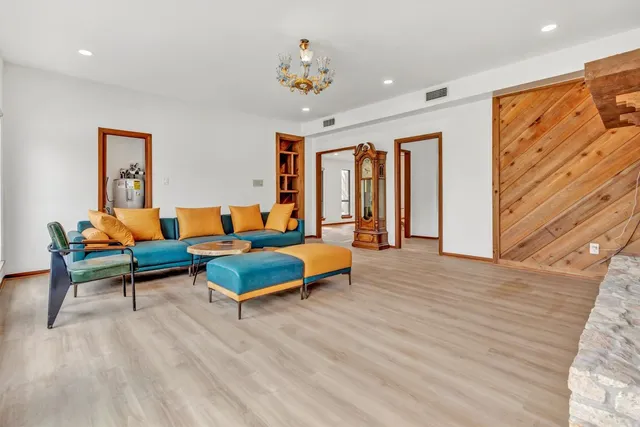 a bedroom with furniture and wooden floor