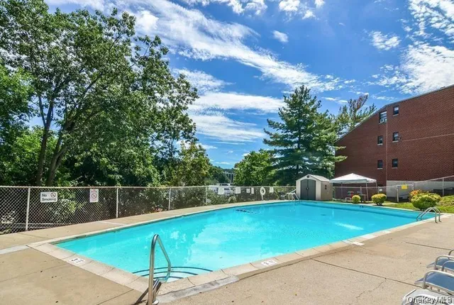 a view of a tennis ground with large trees