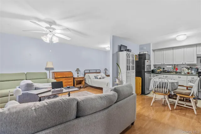 a living room with furniture and kitchen view