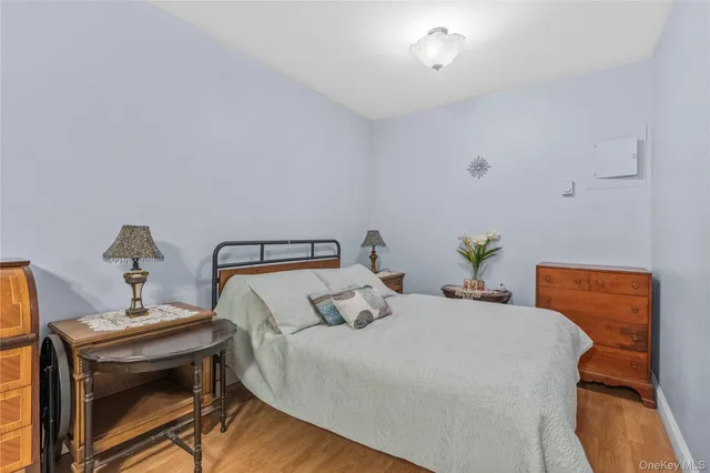 a bedroom with a bed and a lamp on the dresser