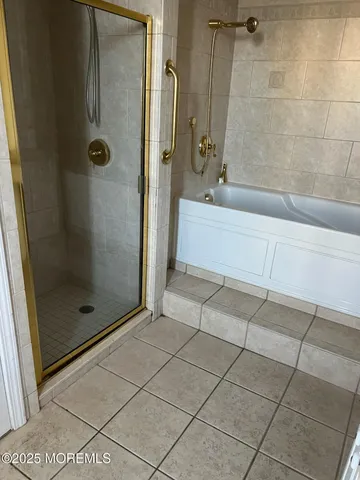 a bathroom with a bathtub and shower