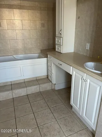 a bathroom with a bathtub and shower