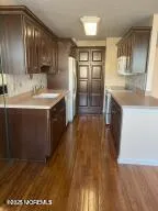 a kitchen with stainless steel appliances granite countertop a sink a stove and a refrigerator