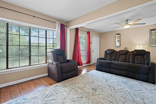 a living room with furniture and a large window