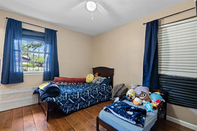 a bedroom with bed and a window