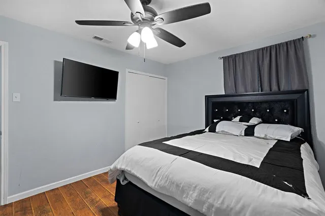 a bedroom with a bed and a flat screen tv