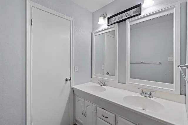 a bathroom with a shower sink and mirror