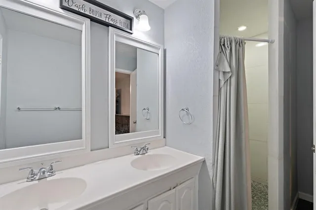 a bathroom with a double vanity sink mirror and double