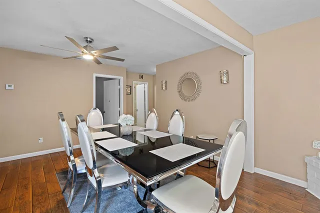 a view of a dining room with furniture and wooden floor