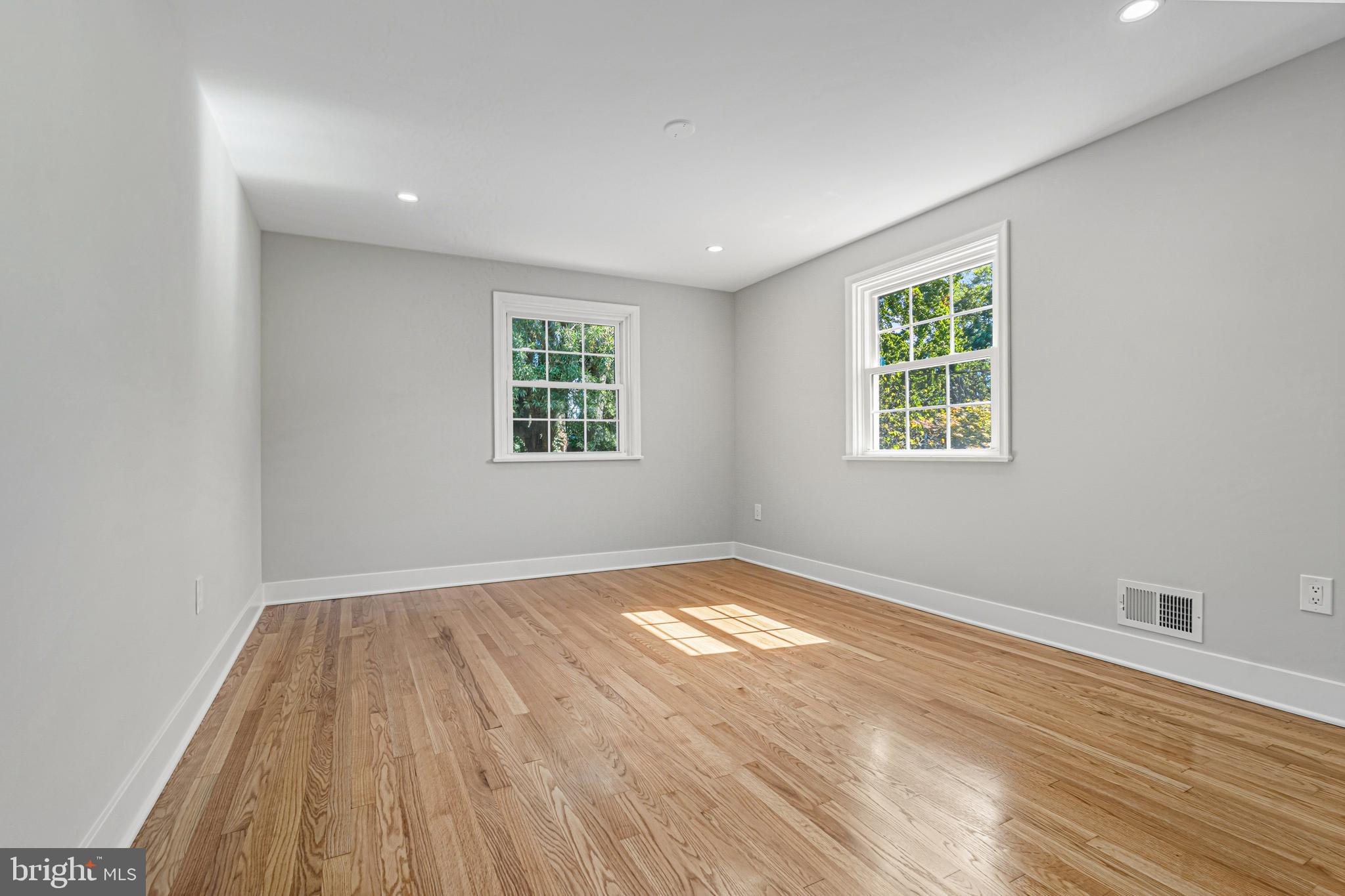 803 Stoneleigh Road Baltimore, MD 21212 - Photo 36 of 56 an empty room with wooden floor and windows
