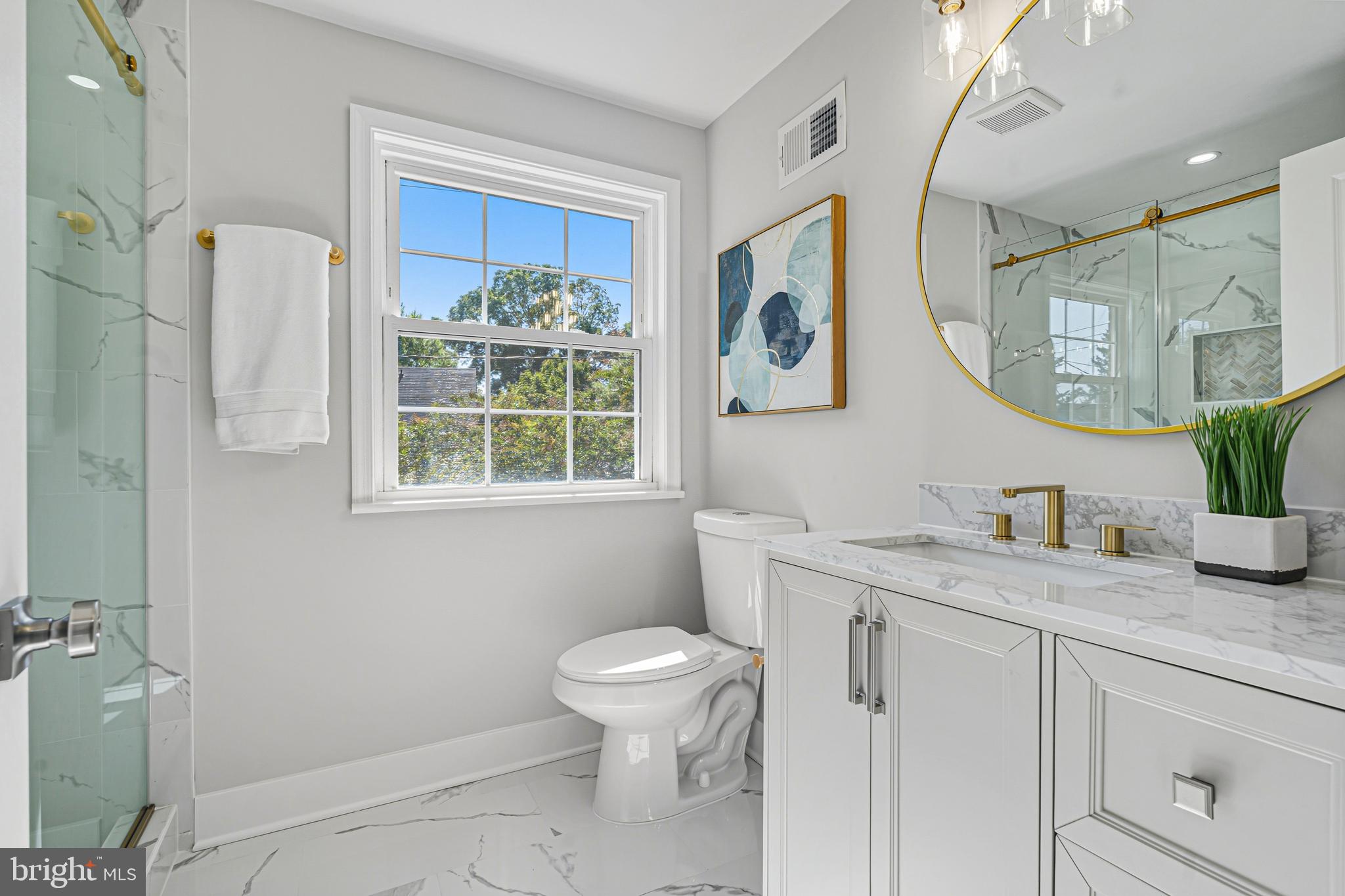 803 Stoneleigh Road Baltimore, MD 21212 - Photo 38 of 56 a bathroom with a granite countertop sink a toilet and a mirror