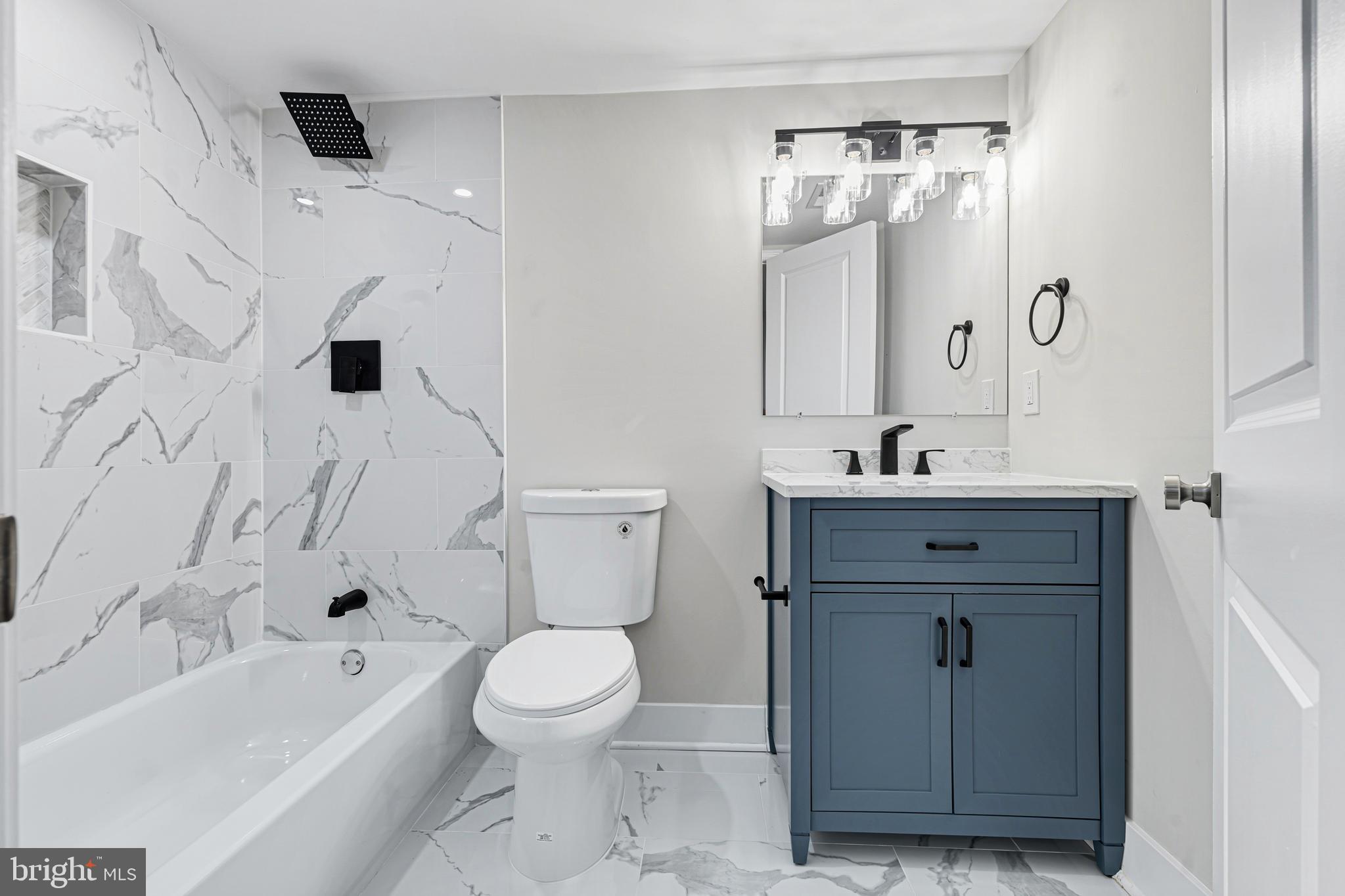 803 Stoneleigh Road Baltimore, MD 21212 - Photo 48 of 56 a bathroom with a sink a toilet and a bathtub