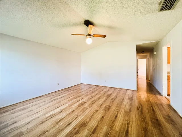 a view of a room with wooden floor