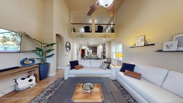 a living room with furniture and a chandelier