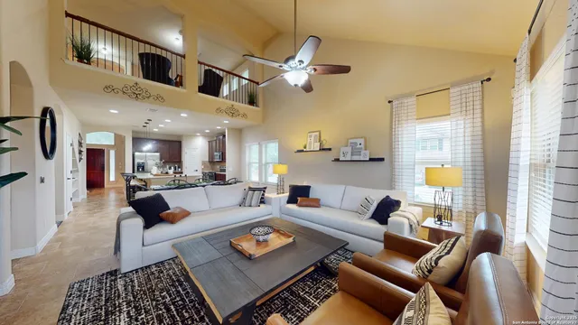 a living room with furniture and a chandelier