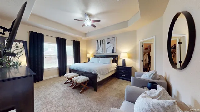 a bed room with a bed mirror and window