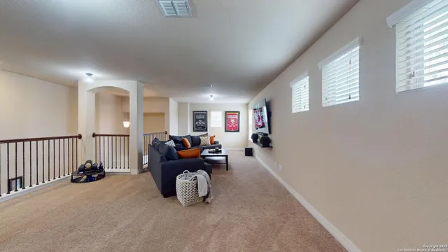 a living room with furniture a window and gym equipment