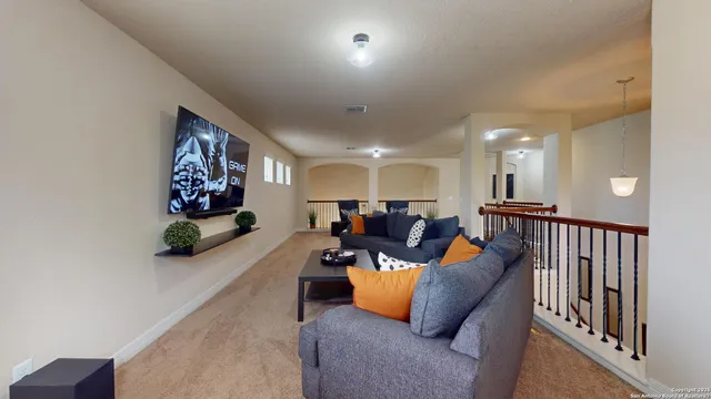 a living room with furniture a couch and a potted plant